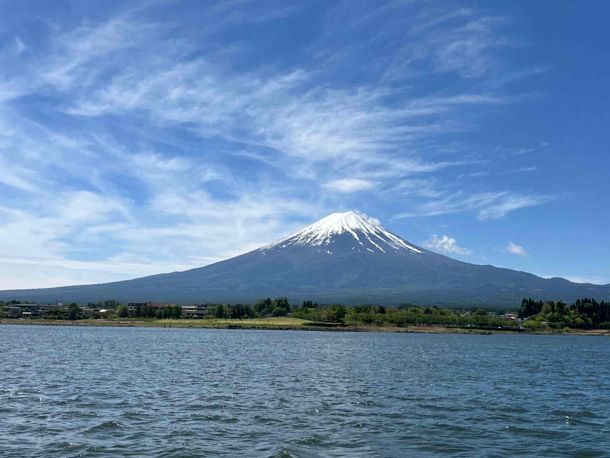 Snow-capped Mount Fuji seen across Lake Kawaguchi on a clear day